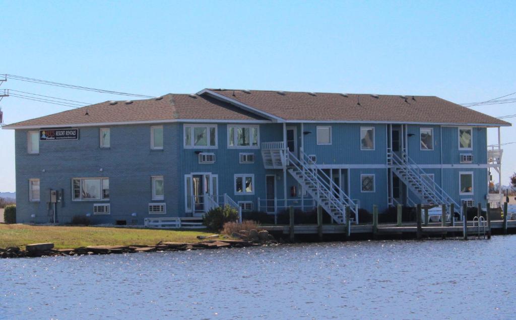 a large blue house on the side of the water at Fin 'N Feather Waterside Inn by Kees Vacations in Nags Head
