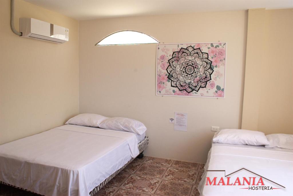 Postel nebo postele na pokoji v ubytování Hostal Malania