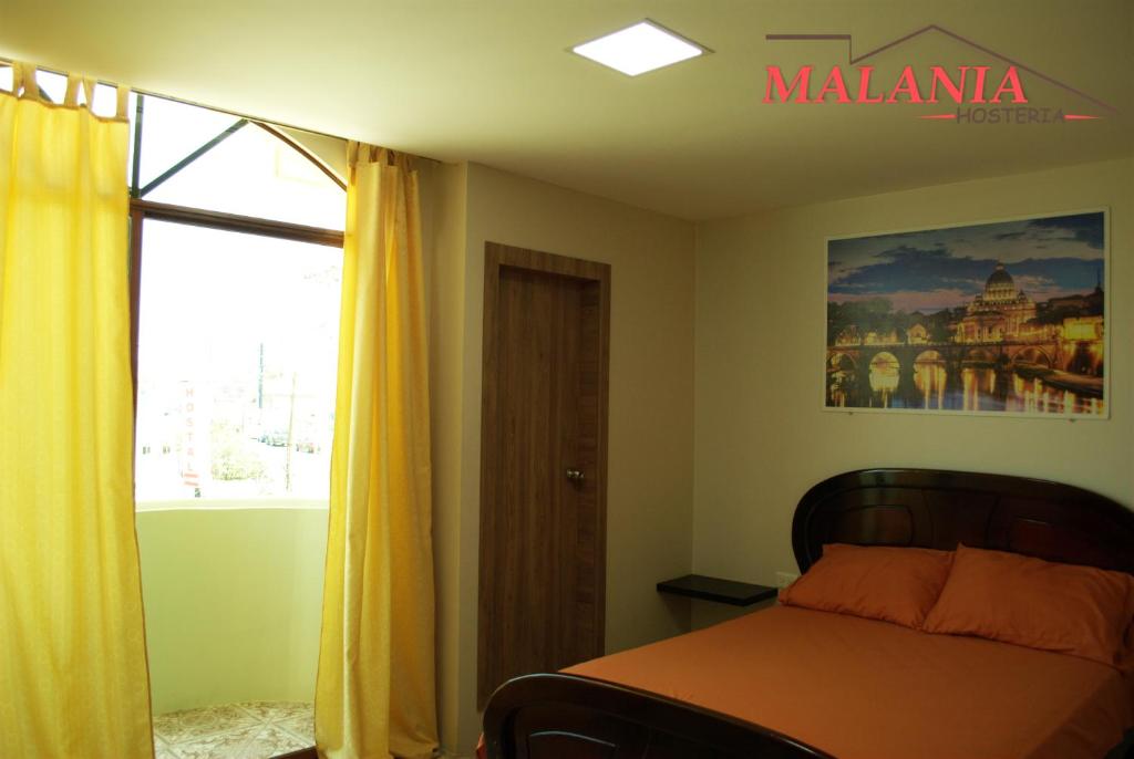 Postel nebo postele na pokoji v ubytování Hostal Malania