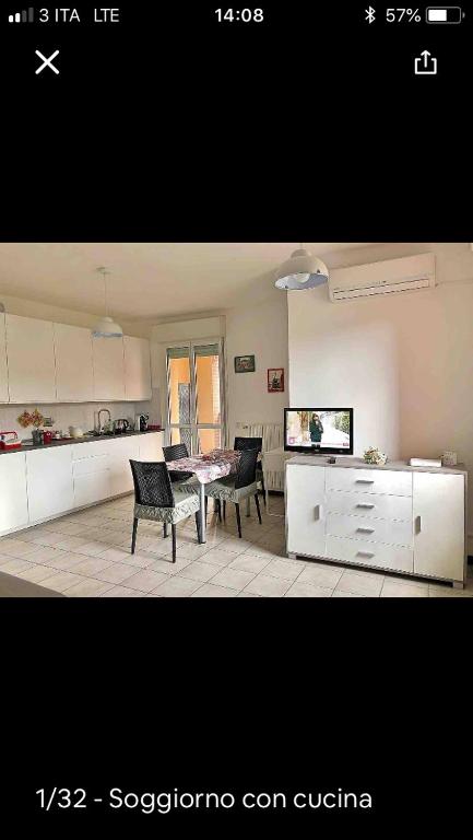 a kitchen with a table and chairs in a room at Leo e Patty Appartamento A Bologna09 in Bologna