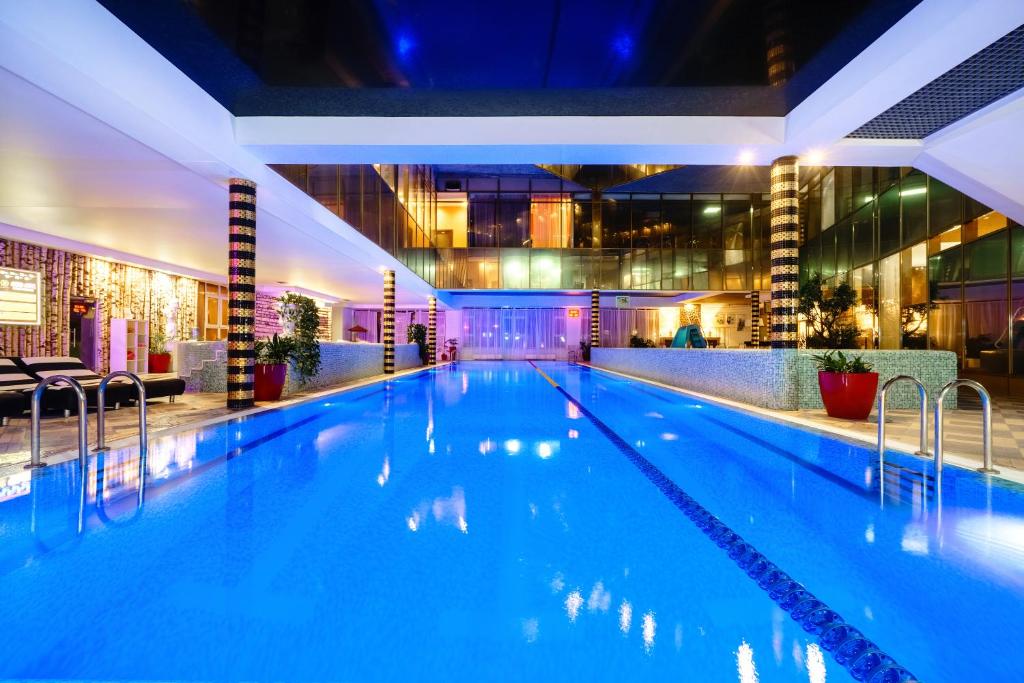 a large swimming pool in a hotel at night at Grand Wellness Novahovo Hotel & Spa in Nikol'skoye-Uryupino