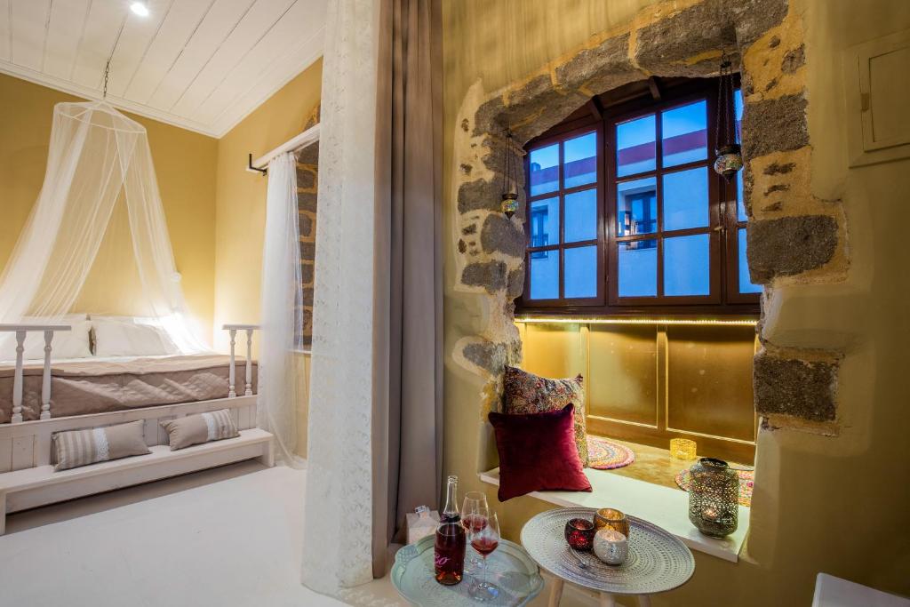 a room with a bed and a table with drinks on it at A33 Rhodes Old Town House in Rhodes Town
