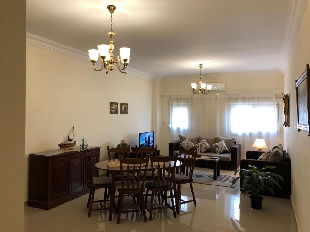 a dining room and living room with a table and chairs at El-Shorouk Housing gate2 in Cairo