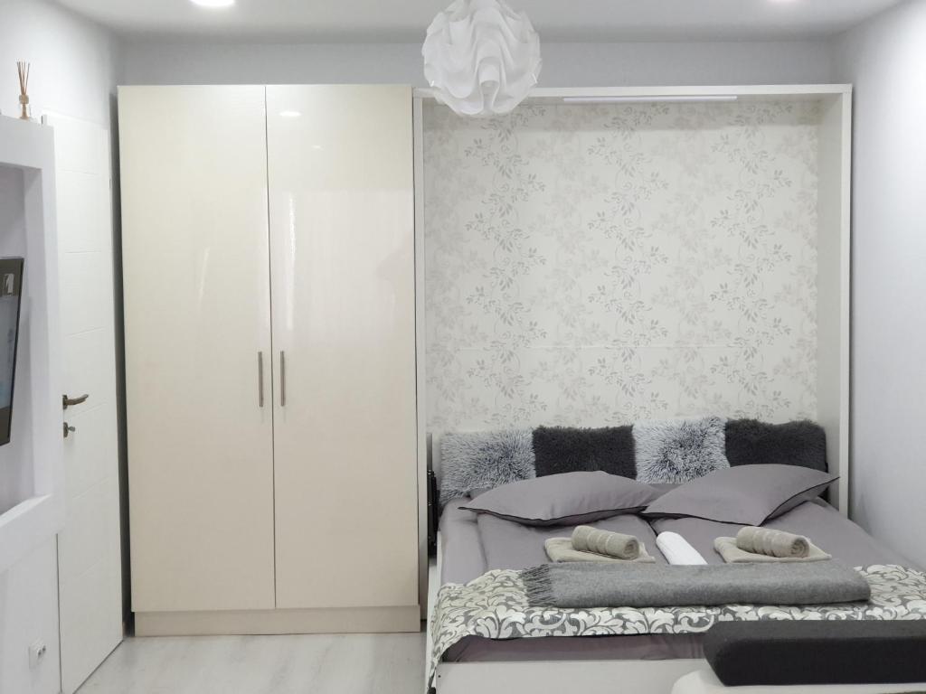 a bedroom with a bed with a wall at The Place in Deva