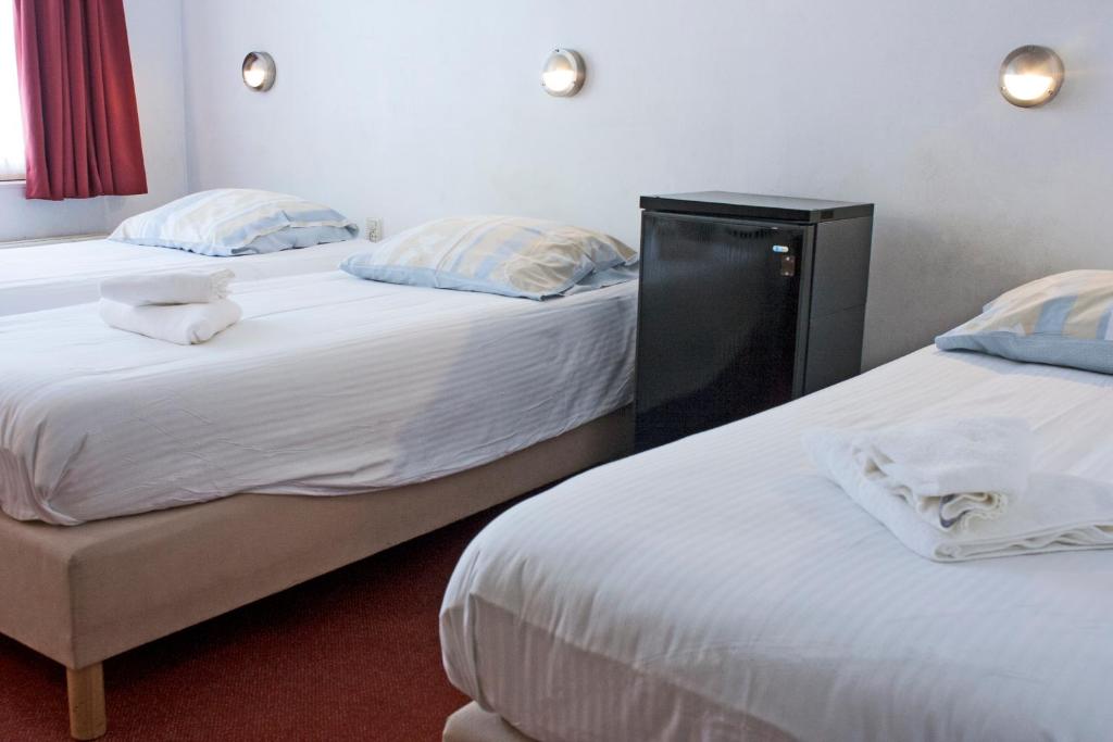 Postel nebo postele na pokoji v ubytování Hotel Torenzicht