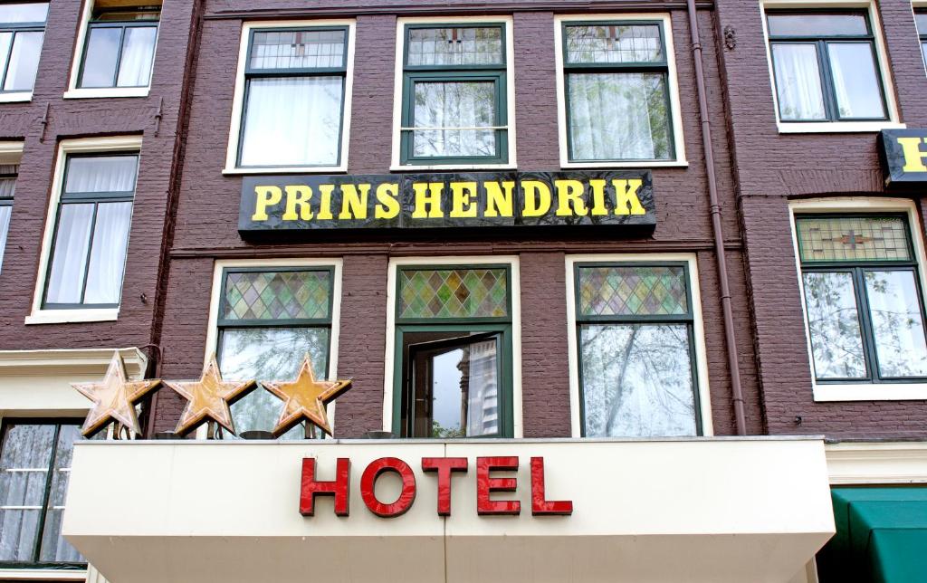 a hotel sign on the side of a brick building at Hotel Prins Hendrik in Amsterdam