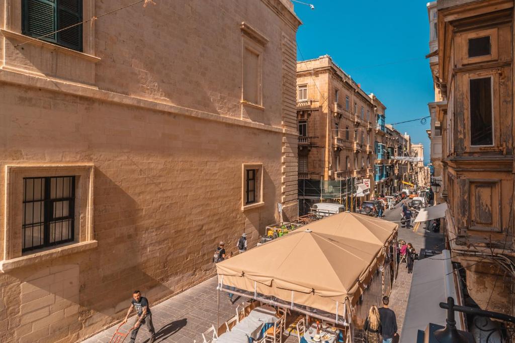 a street with a tent in the middle of a building at Valletta Collection - GB Suites in Valletta