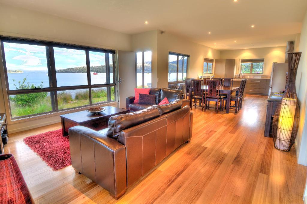 a living room with a leather couch and a table at Tides Reach in Dover