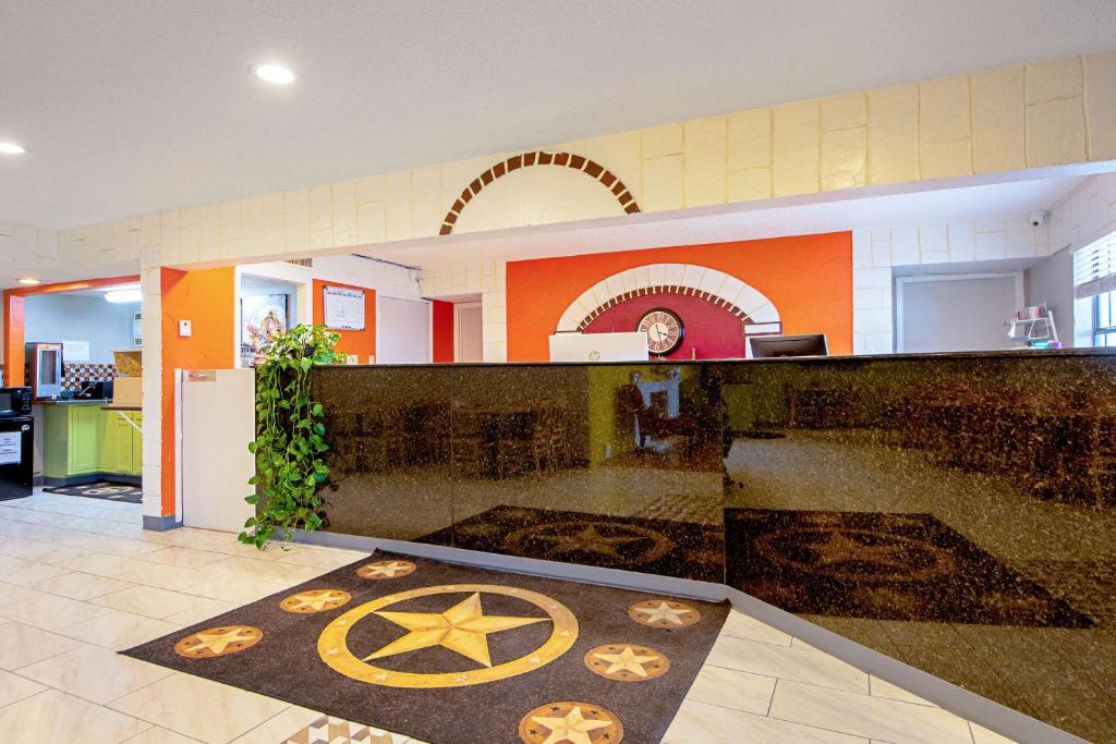 a lobby with a star rug on the floor at Economy Inn & Suites in Denton