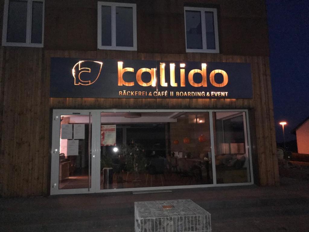 un restaurante con un cartel en la parte delantera en Kallido, en Hermeskeil
