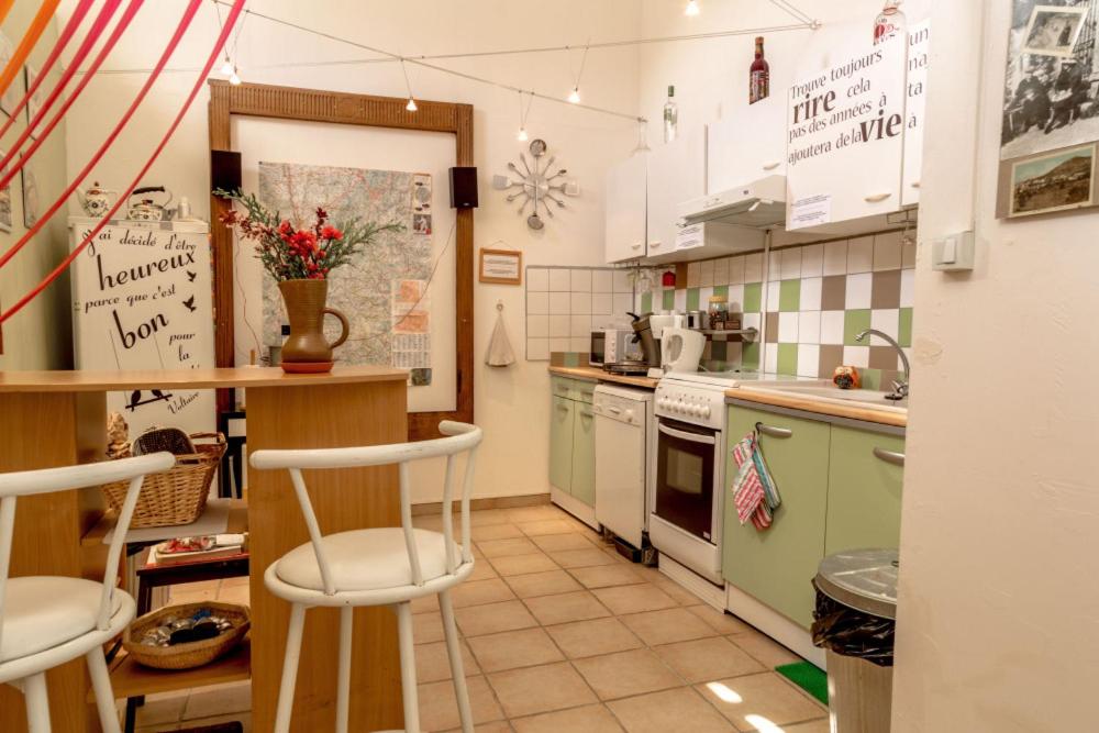 a kitchen with green and white appliances and a counter at Gîte Chambres d&#39;hôtes Le Bellevue in Montbrun-les-Bains