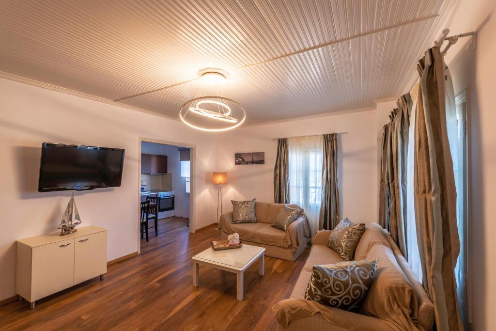 a living room with a couch and a tv at Anastasia House in Panagia