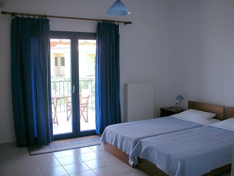 Postel nebo postele na pokoji v ubytování Hotel Alexandros