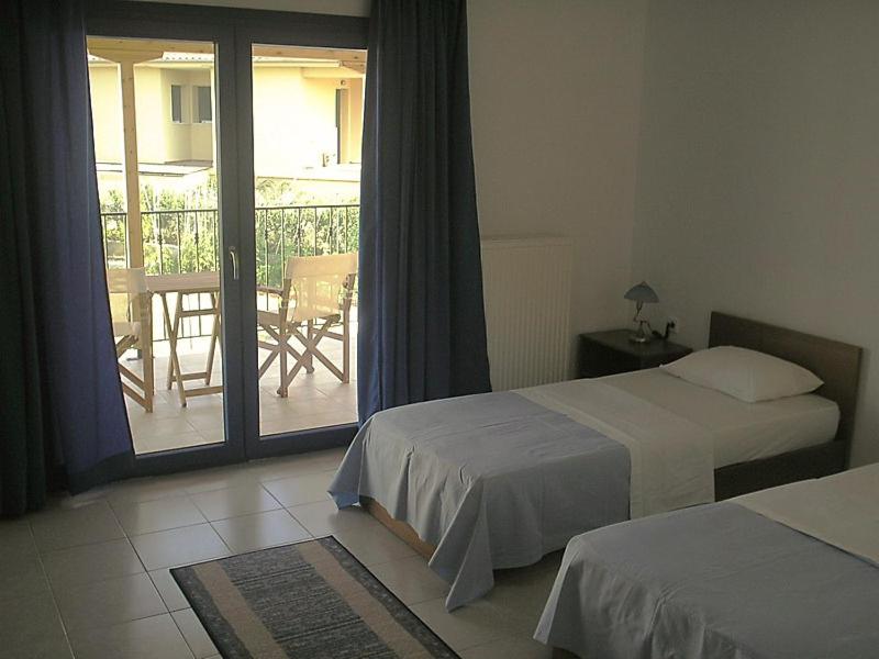 Postel nebo postele na pokoji v ubytování Hotel Alexandros
