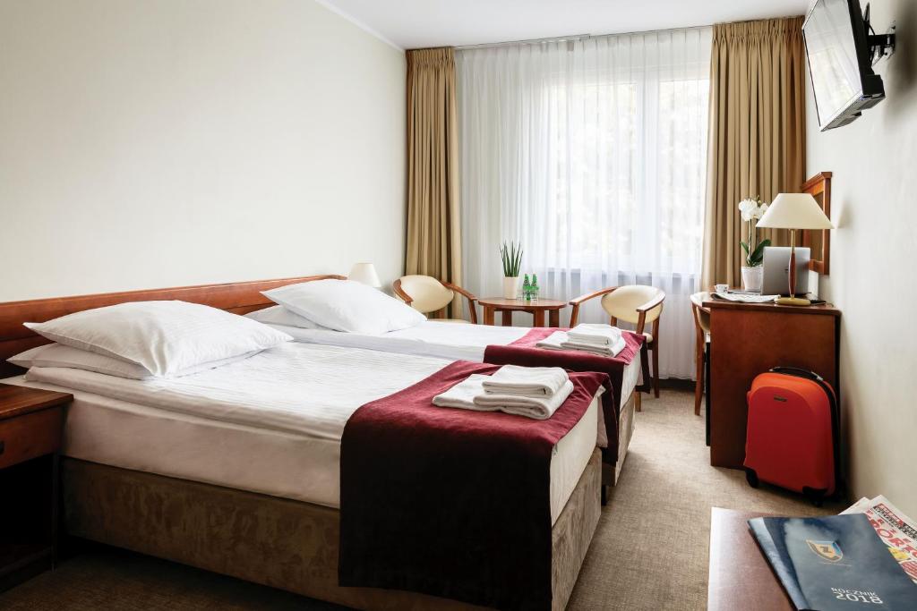 Posteľ alebo postele v izbe v ubytovaní Hotel Zawisza