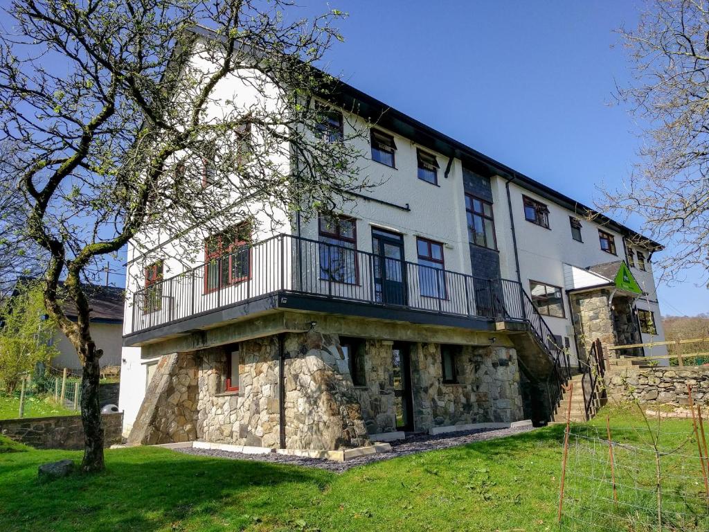 a large white building with a balcony on top of it at YHA Snowdon Llanberis in Llanberis