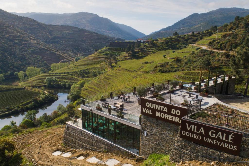 a sign for a winery in a valley with a river at Vila Gale Douro Vineyards in Armamar