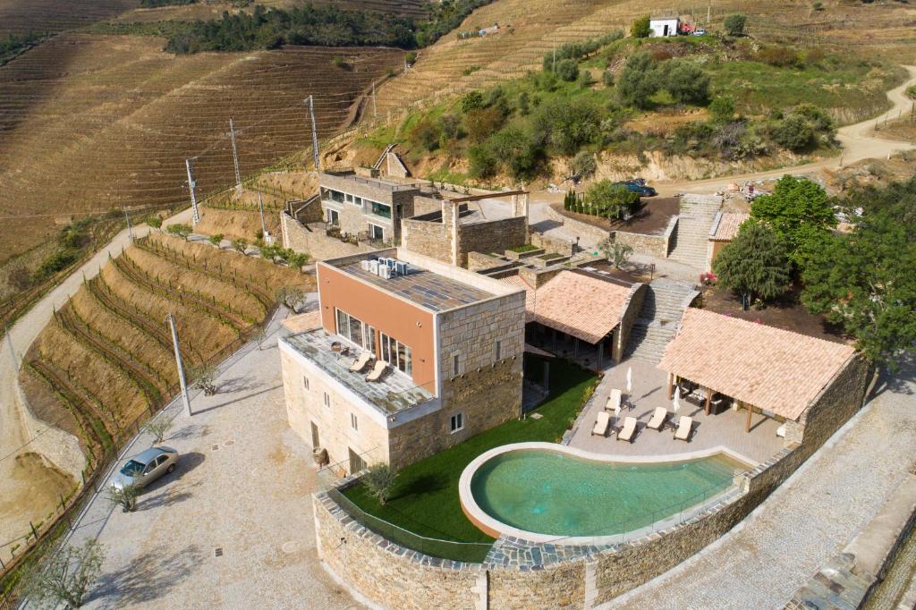 an aerial view of a building with a pool at Vila Gale Douro Vineyards in Armamar