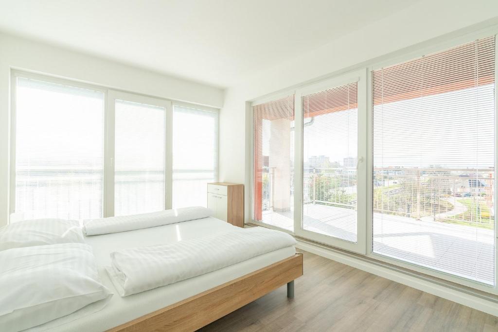 Posteľ alebo postele v izbe v ubytovaní Apartmány Noviny