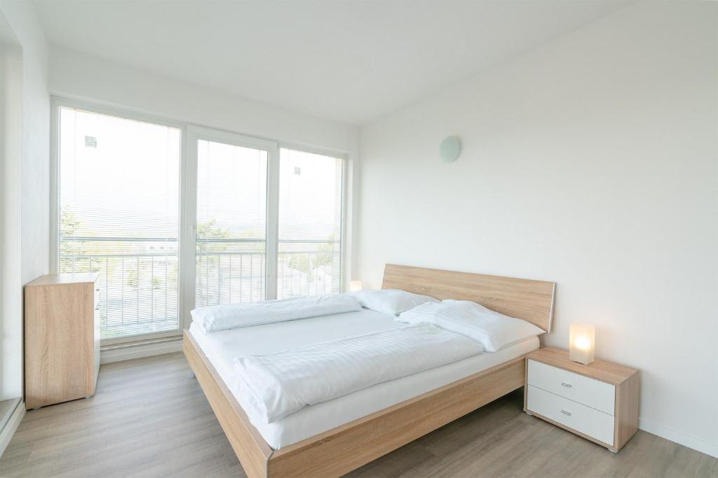 Posteľ alebo postele v izbe v ubytovaní Apartmány Noviny