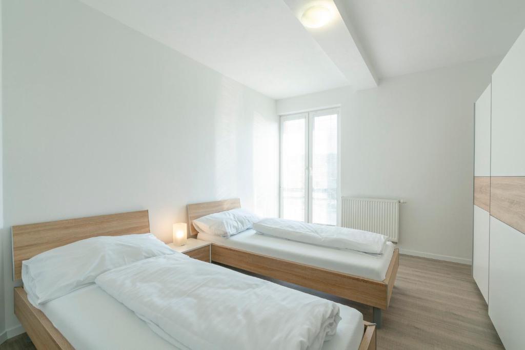 Posteľ alebo postele v izbe v ubytovaní Apartmány Noviny