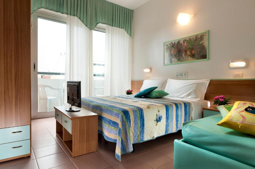Postel nebo postele na pokoji v ubytování Hotel Napoleon