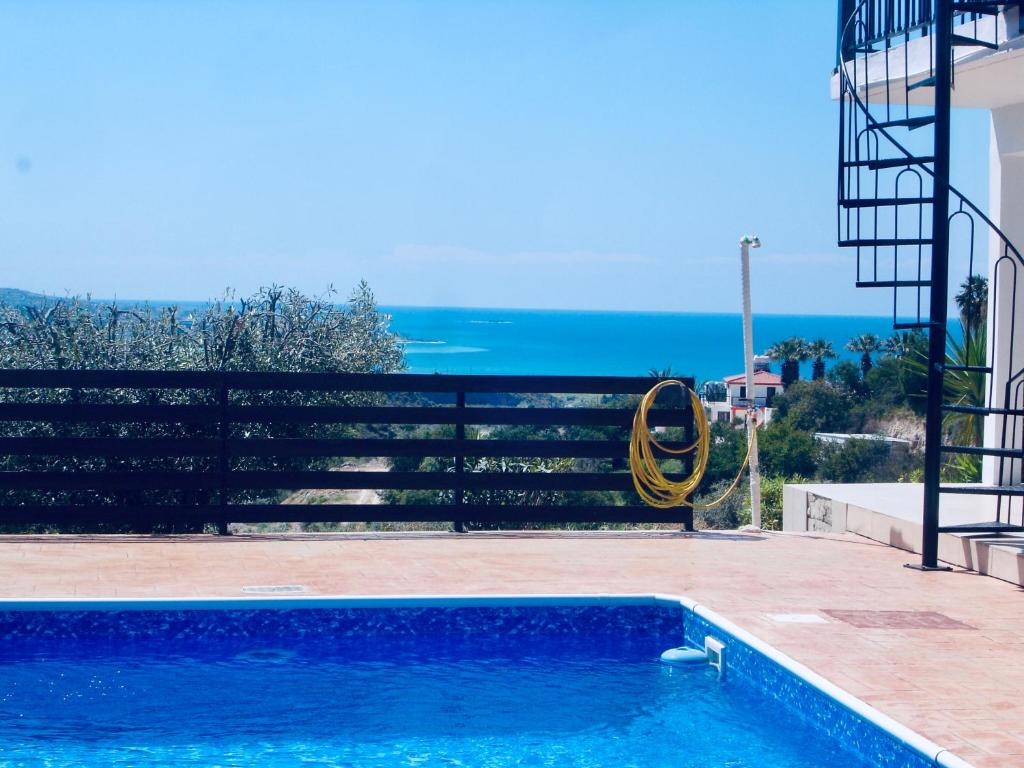 a swimming pool with a view of the ocean at Serene Serenity in Paphos