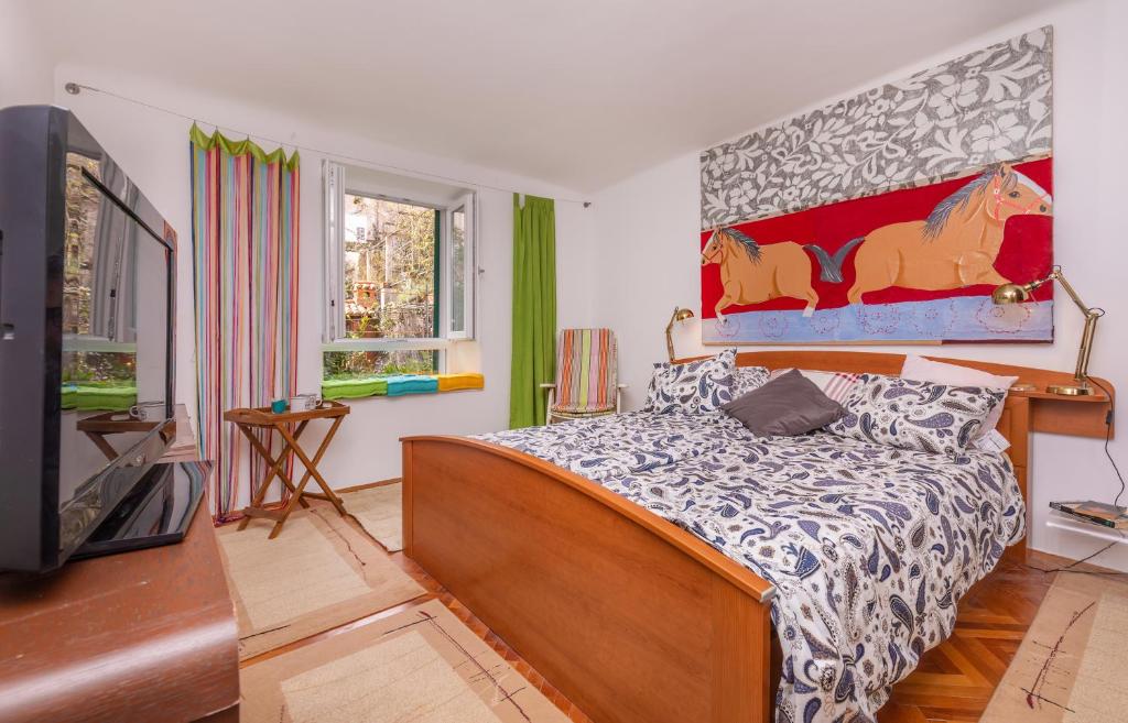 a bedroom with a bed and a tv in it at The Art Republic, Old Town in Dubrovnik