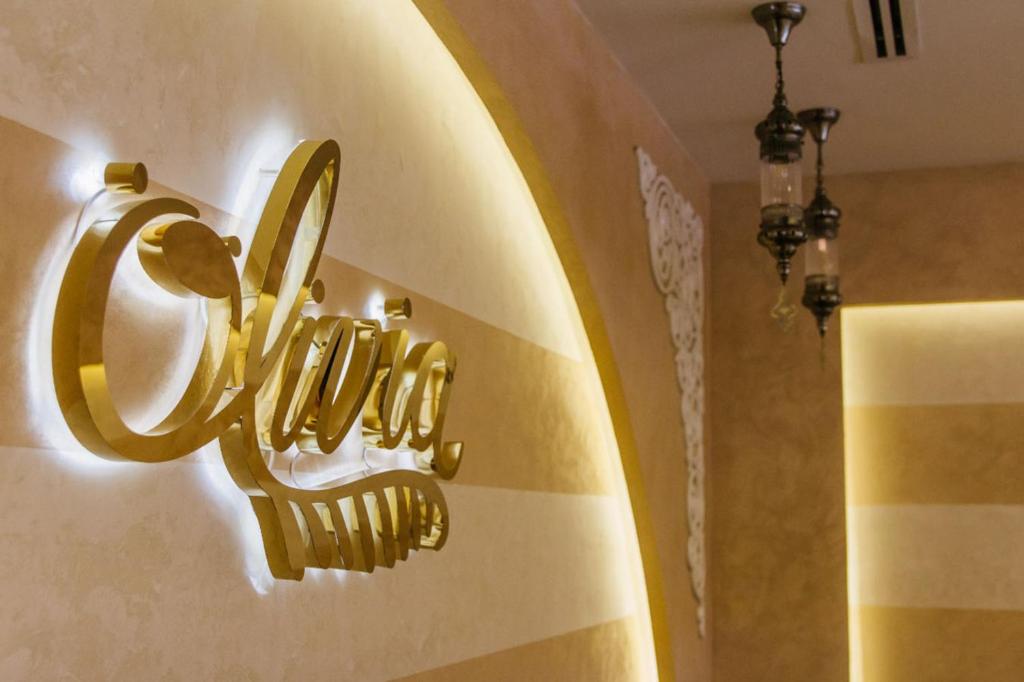 a gold lightswitch on the wall of a bathroom at Mangrove Hotel in Ras al Khaimah