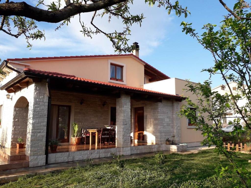 a house with a patio in front of it at Apartman Ulika in Medulin