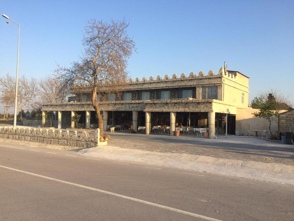 a large building on the side of a street at Hotel Hisarlık in Halileli