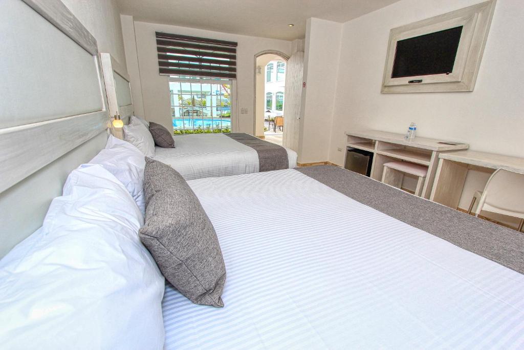 Postel nebo postele na pokoji v ubytování Hotel Splash Inn