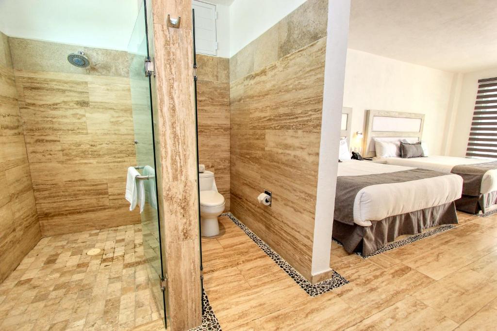 Postel nebo postele na pokoji v ubytování Hotel Splash Inn