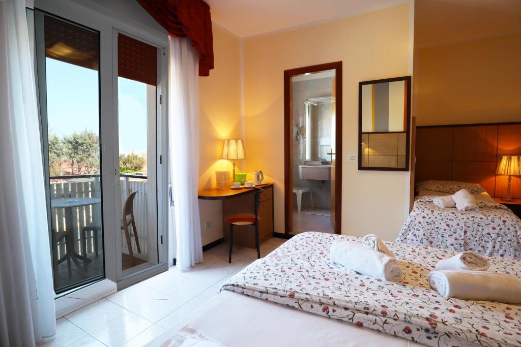 Postel nebo postele na pokoji v ubytování Hotel Righetto Fronte Mare
