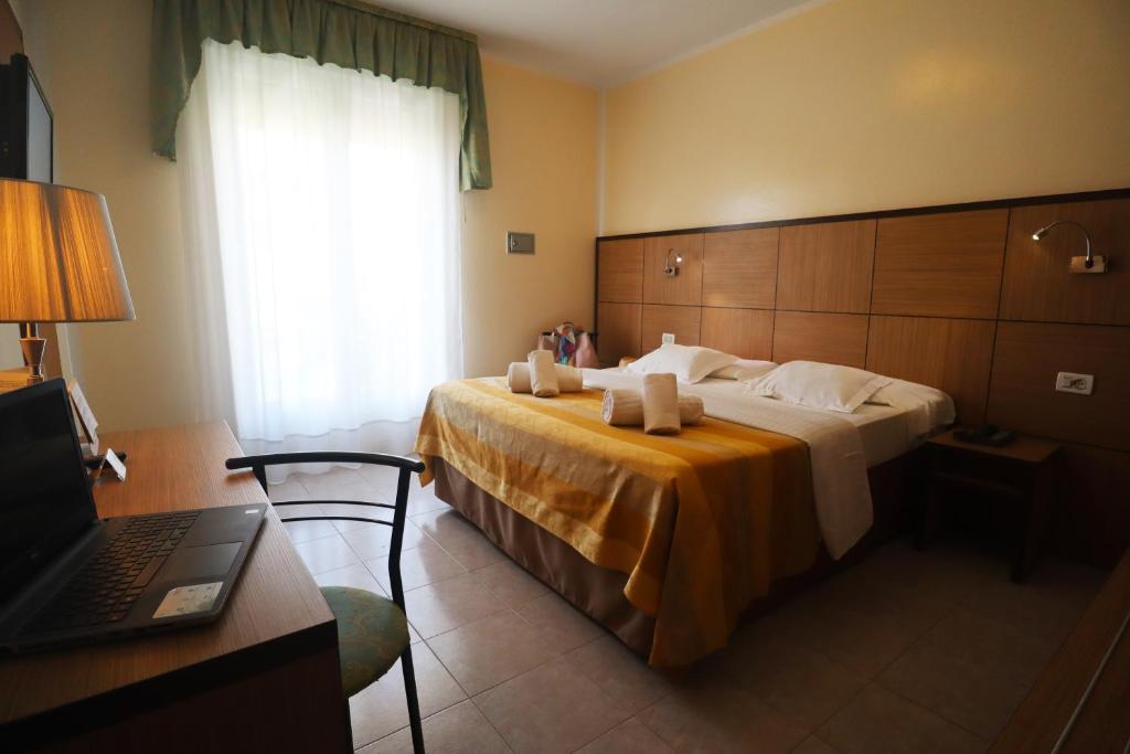 Postel nebo postele na pokoji v ubytování Hotel Righetto Fronte Mare