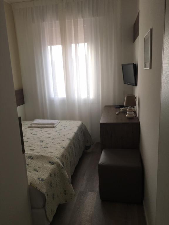 Postel nebo postele na pokoji v ubytování Albergo Rosa