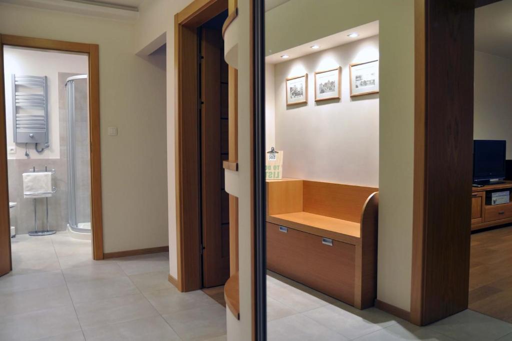 a bathroom with a sink and a mirror at Perła Bałtyku - 4 osobowy Apartament w Sopocie in Sopot