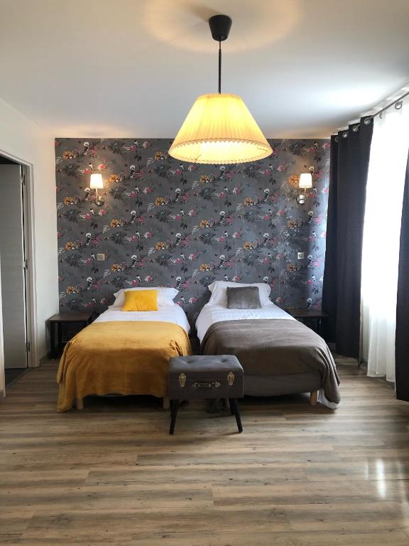 Postel nebo postele na pokoji v ubytování Hôtel L'ange de la vallée