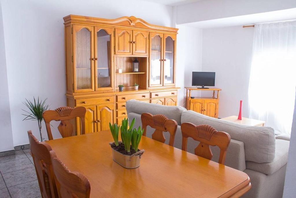 a living room with a table and a couch at APARTAMENTO LOS NARCISOS in Chulilla