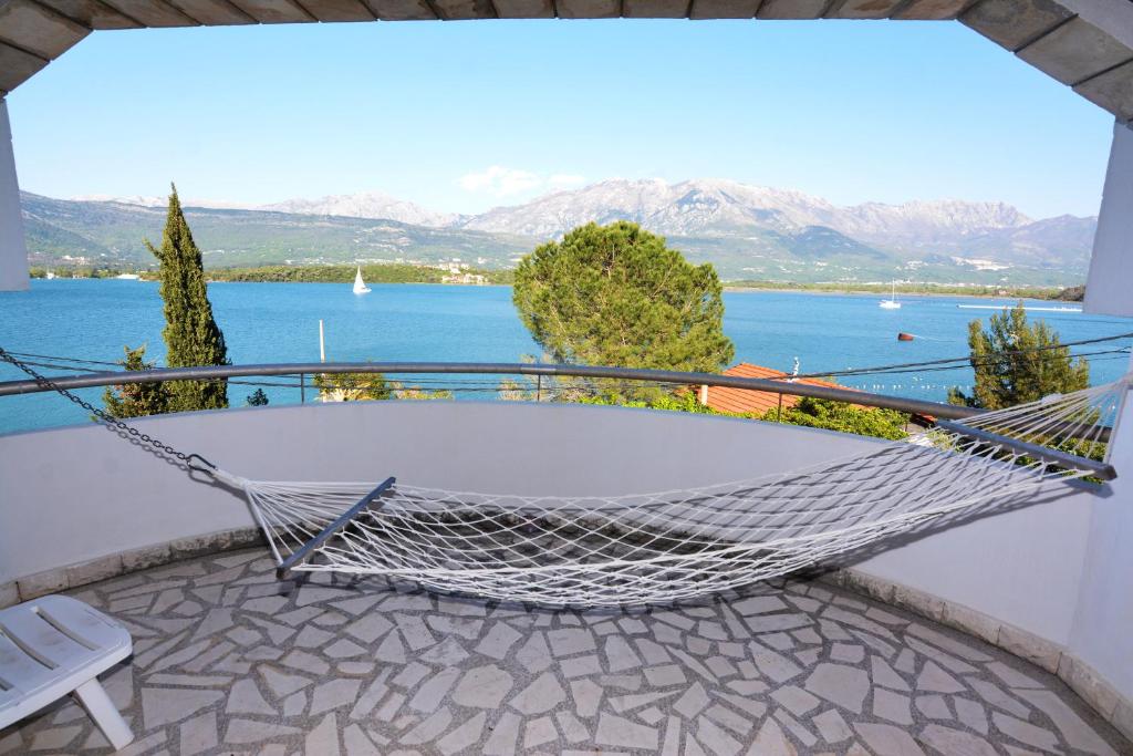 a hammock on a balcony with a view of the water at Luxury Villas Marko in Tivat