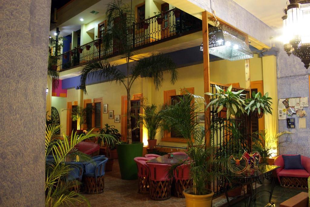 un restaurante con mesas, sillas y plantas en Casa Vilasanta, en Guadalajara