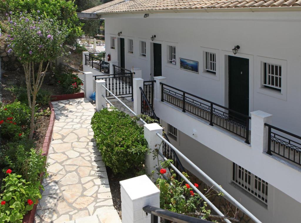 a balcony of a house with flowers and plants at Sea View in Paleokastritsa