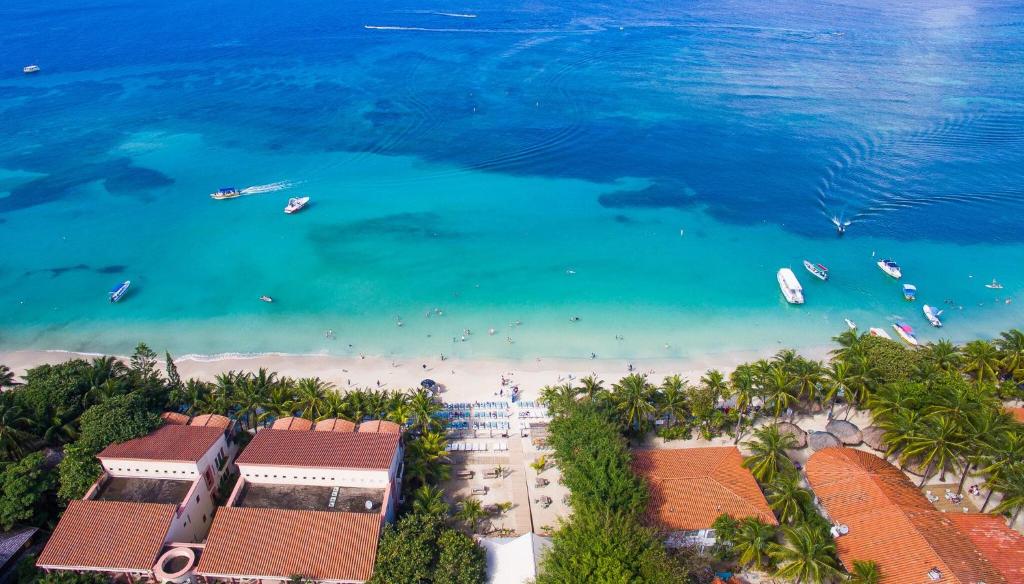 an aerial view of a beach with boats in the water at Mayan Princess Beach & Dive Resort in West Bay