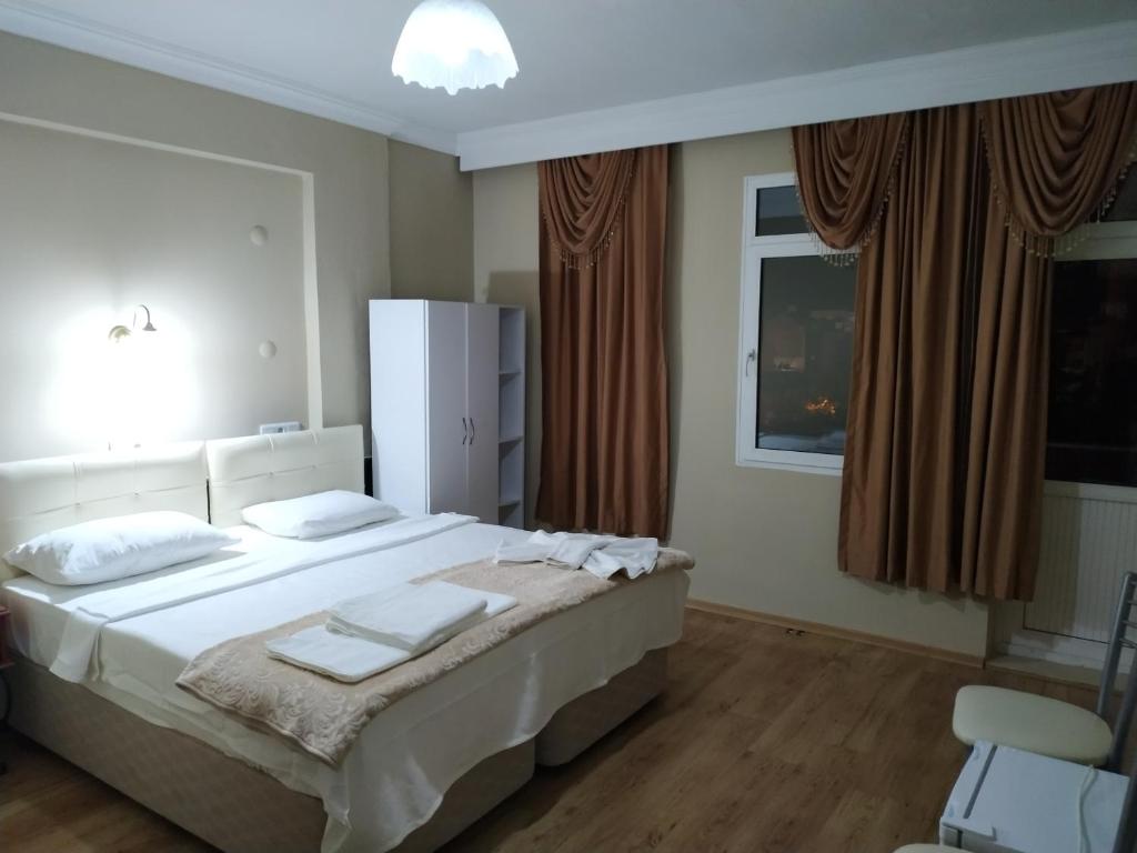 a bedroom with a bed with towels on it at EPHESUS CENTRUM in Selcuk