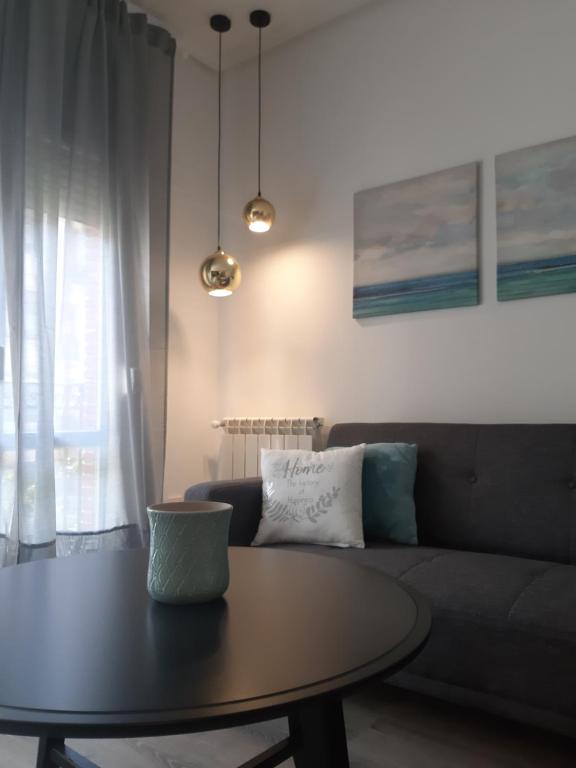 a living room with a table and a couch at La parada de Conde Aranda in Zaragoza