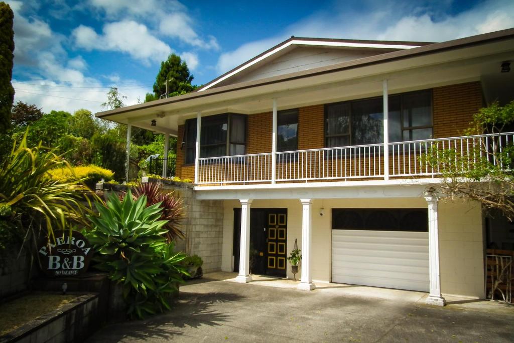 a brick house with a white garage at Paeroa bed and breakfast in Paeroa