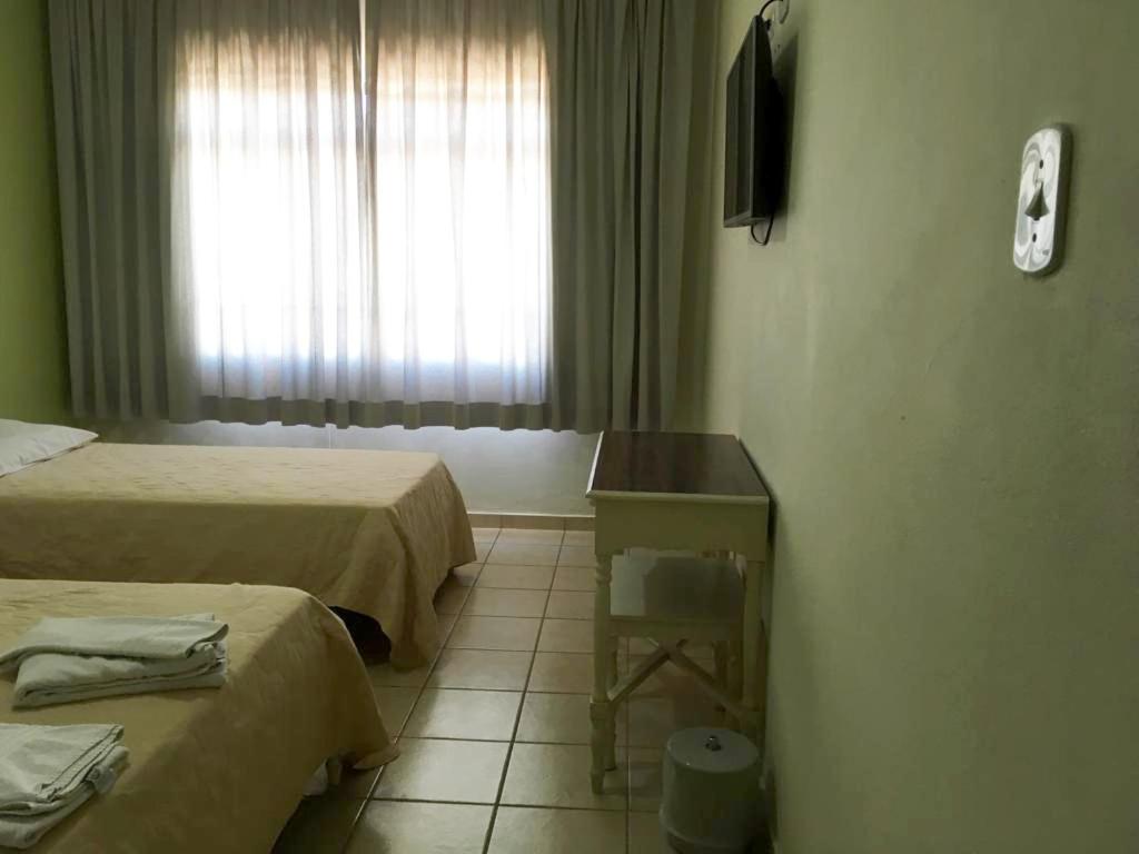 Postel nebo postele na pokoji v ubytování Apucarana Palace Hotel