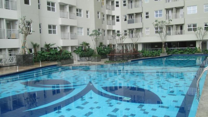 a large swimming pool in front of a building at Wood Hotel Bandung in Bandung