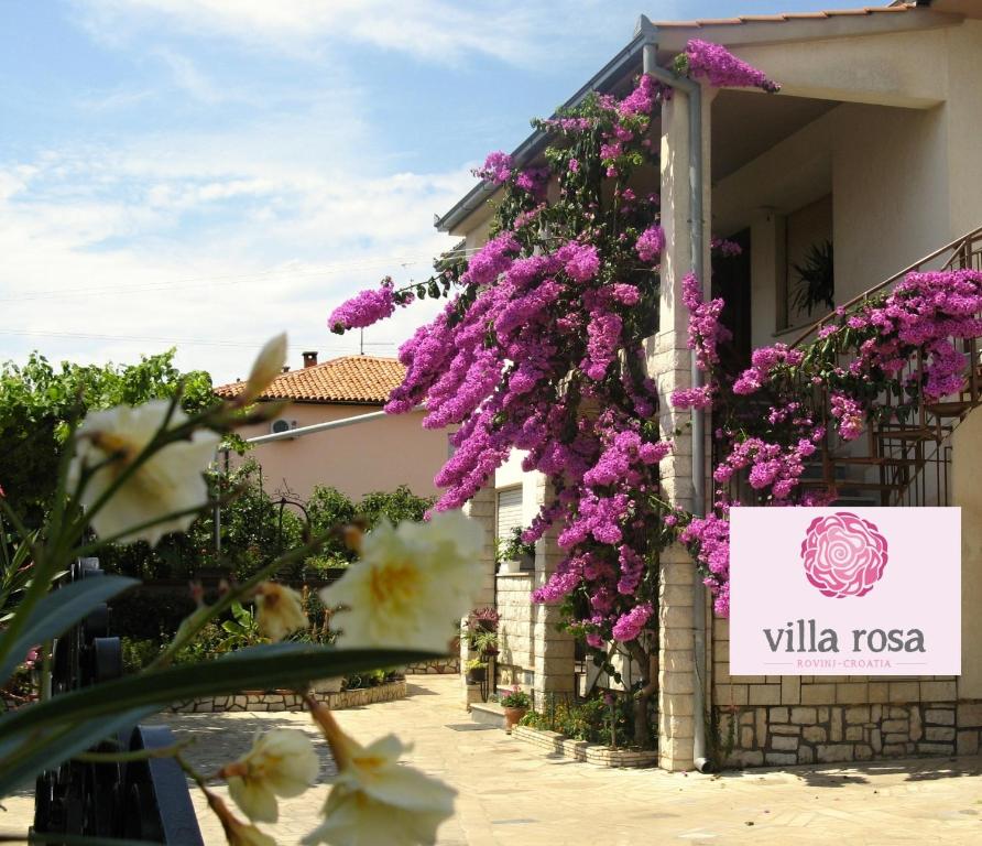 a building with flowers on the side of it at Apartments Villa Rosa in Rovinj