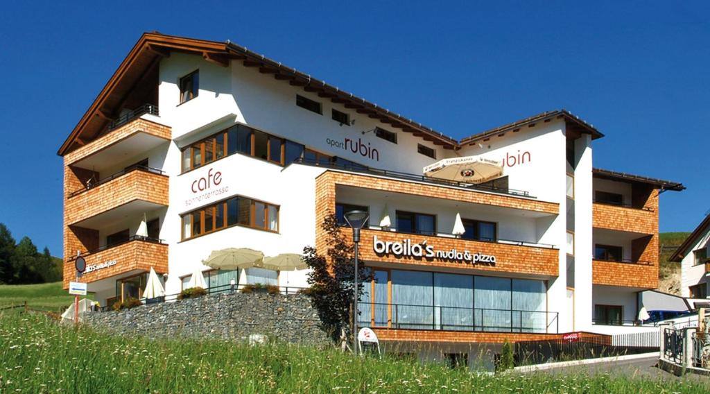 a building with a sign on the side of it at Apart Rubin in Serfaus